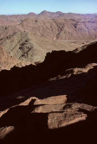 View to the east, from above the level of Elijah's Basin, on the Steps of Repentance, the most popular route for visitors climbing Mt Sinai from St Catherine's Monastery in Wadi ed-Deir. The mountain in the left middle-gound and topped by a small white structure (a church dedicated to two Roman soldier Christian martyrs) is Gebel el Muneiyah which is shown in westward views, from Wadi es Sadad, by images 1 to 12.  