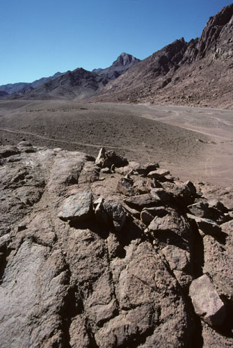 Mount Sinai, height 2382m, also called Mt Horeb in the scriptures, seen upper mid-picture in a south-westward view from the plain of Wadi es Sadad about 2 kilometers north of its junction with Wadi Sebaiyeh. The closer, darker mountain seen here to the left of Mt Sinai is Jebel el Muneijah, height 1825m, believed by some to be the true Mt Moses, or Jebel Musa, where the Law was given. 