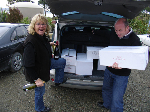 A trunk-load of Sam Neill's wines being gleefully received by the legendary entrepreneur and amazing hostess Fleur Sullivan, creator and proprietor of "Fleur's Place", the superb and justifiably famed seafood restaurant at the tiny fishing village of Moeraki in North Otago, New Zealand. The deliveryman is none less than Mark Fields, Sam's genial right-hand man and manager of his Two Paddocks wine growing operation in Central Otago, with its main office on Sam's home property near Queenstown. 