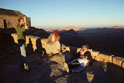 Visitor and Bedouin guides in walled area, including Christian Chapel (left-picture), on summit of Mt Sinai at sunset. The shadowed peak centre-picture is Gebel el Muneijah, well shown in westward views from Wadi es Sadad by images 1 to 12 of this collection. 