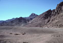 Mount Sinai, height 2382m, also called Mt Horeb in the scriptures, seen upper mid-picture in this south-westward view from Wadi es Sadad about 2 kilometers north of its junction with Wadi Sebaiyeh. The closer, darker mountain see here to the left of Mt Sinai is Jebel el Muneijah, height 1825m, believed by some to be the true Mt Moses, or Jebel Musa, where the Law was given. 