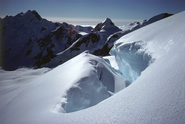 Tasman Glacier: upper neve with bergschrund on south slope of Hochstetter Dome. From left to right in background are Mts Green, Walter and Elie de Beaumont.