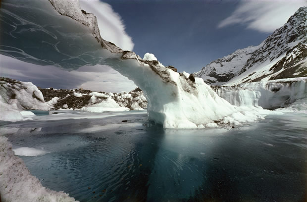 Tasman Glacier: Southward view, in summer, of melt-pool and rapidly-thinning ice-bridge shown distantly by image 17 of this collection.    