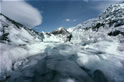 Southward view of melt-pool on the lower Tasman Glacier. The ice bridge, visible left-of-centre of the distant waterline here, is portrayed close-up by image 42 of this collection.